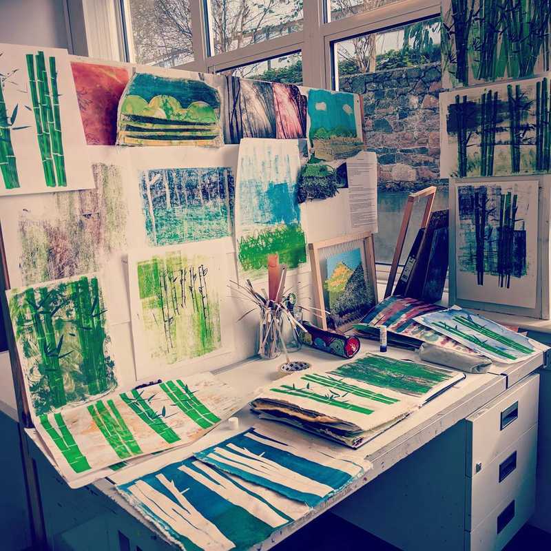 Close up photo of my art studio at college containing a number of drawings and paintings.